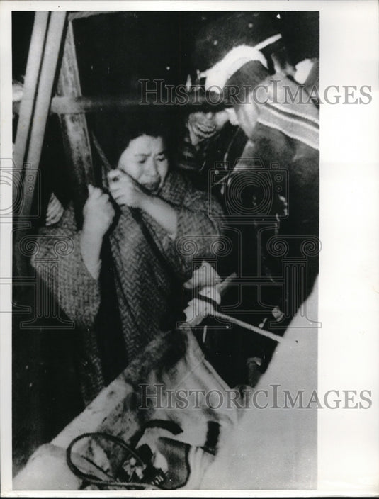 1963 Press Photo Unidentified woman reacts to seeing her husband's mine equipment at Omuta City, Jap - Historic Images