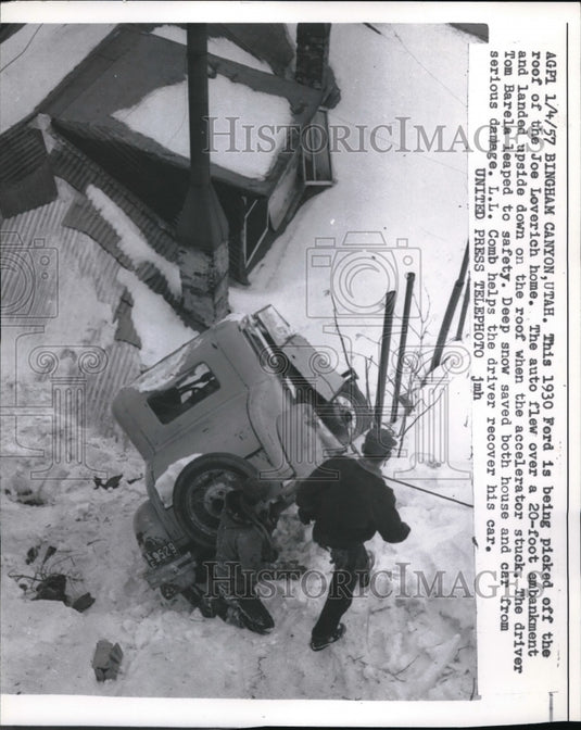 1957 This 1930 Ford is being picked off roof of Joe Loverich Home - Historic Images
