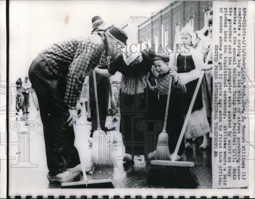 1960 Gov. Mennen Williams comforts child Holland Tulip Time Festival - Historic Images