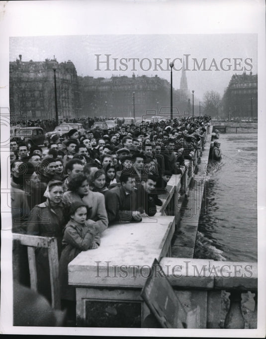 1955 Paris crowds at Alma Bridge watch rising floodwaters-Historic Images