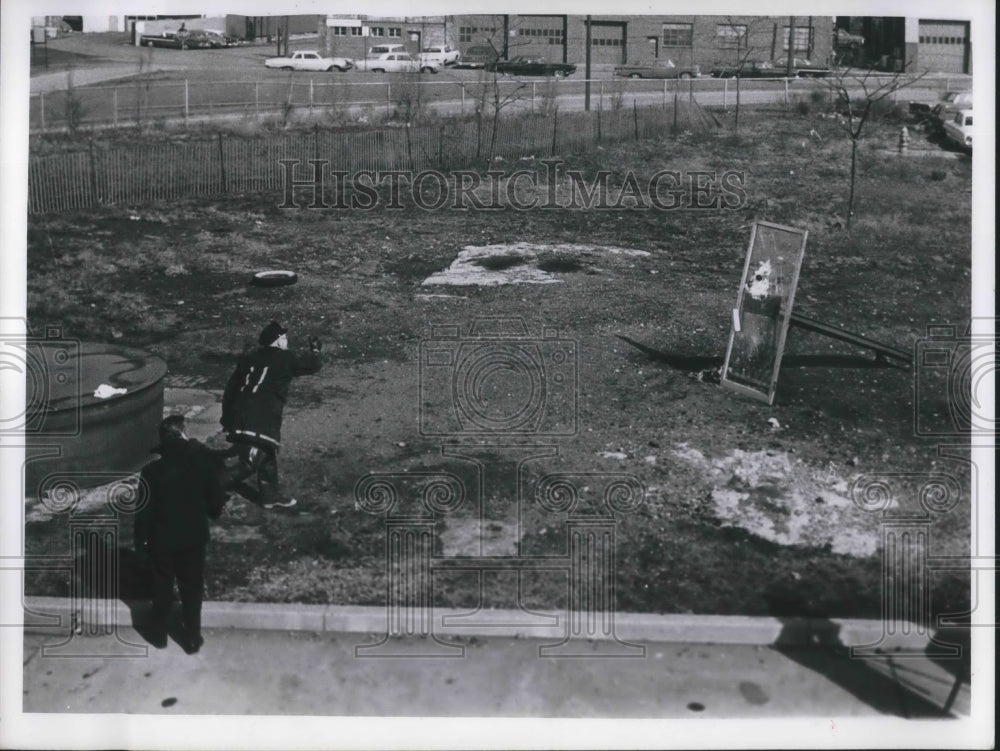 Press Photo Firemen throwing molotov cocktail at shatterproof glass - Historic Images