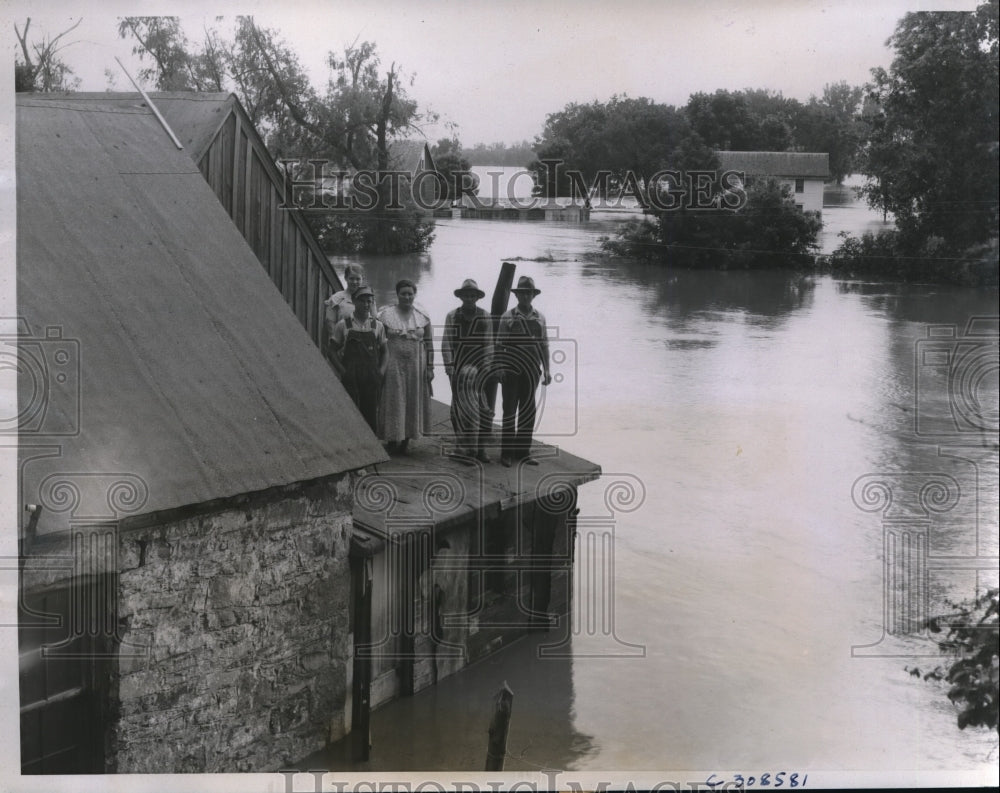 1935 Press Photo Family takes refuge on roof as flood reaches home in Kansas - Historic Images