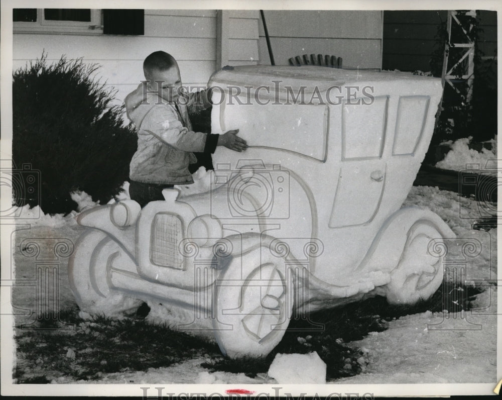 1960 Press Photo Danny Schneller admires Model A Ford snow sculpture in Denver-Historic Images