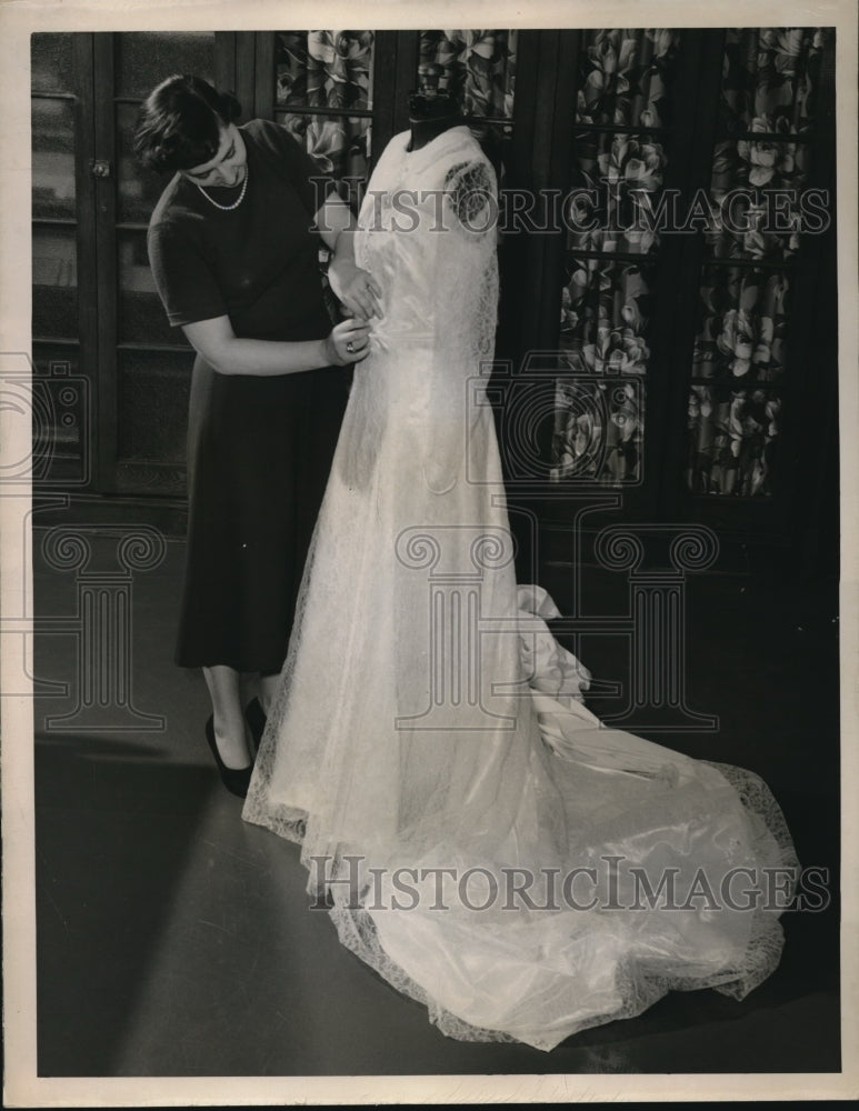 1950 Press Photo Mary McGovern, OF Burton on finishing touch to her wedding gown - Historic Images