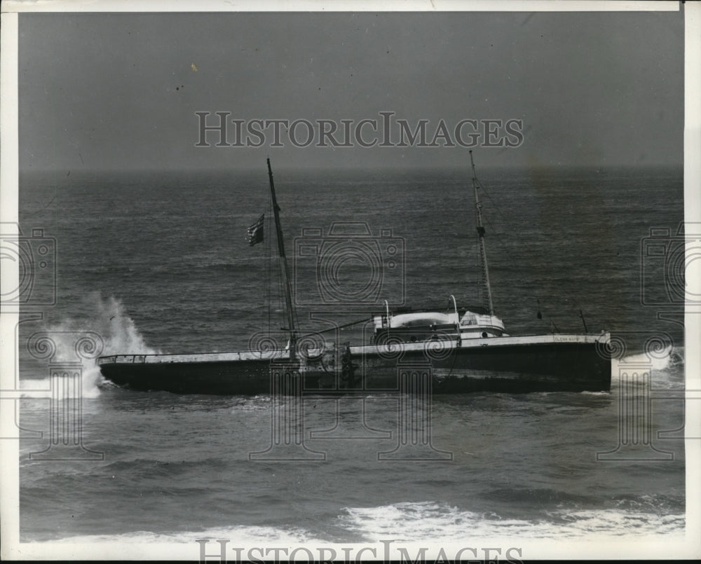 1939 Glenn Mayne hangs at half and an upside down American flag - Historic Images