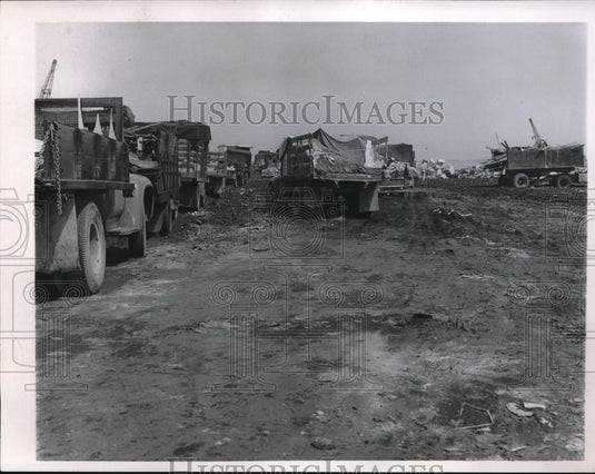 1957 Trucks gumping trash at Cleveland city dumps - Historic Images