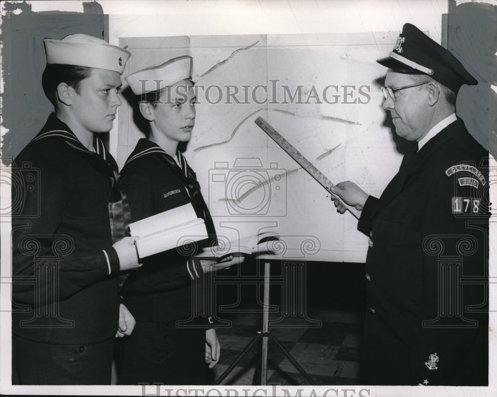 1957 Press Photo Mapping out weekend cruise - Historic Images