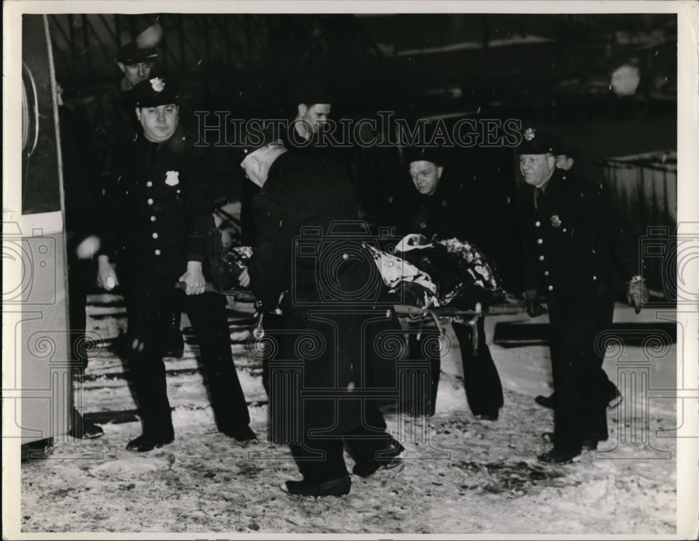 1942 Cleveland firemen rescue a victim from the river - Historic Images