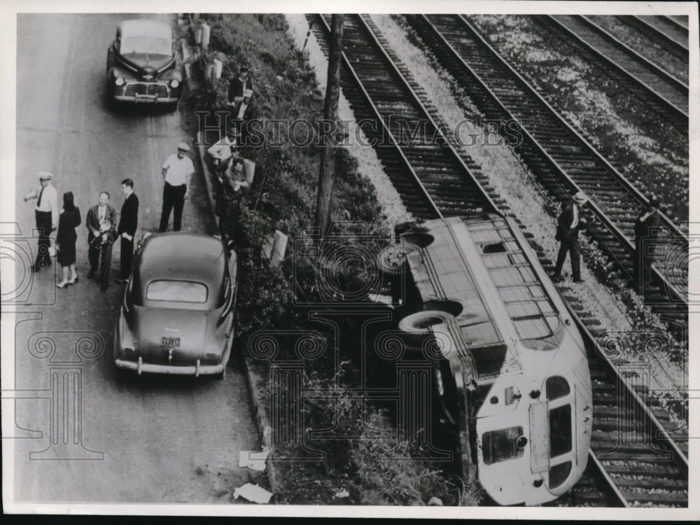 1946 Press Photo Bus Accident Hitting Fence and Landing on Railroad Tracks - Historic Images