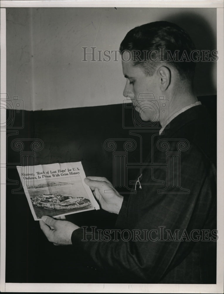 1937 Press Photo Mr. Davis holding a photo of a boat going to Alcatraz Island - Historic Images