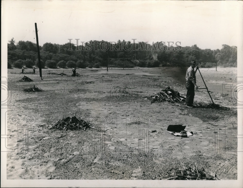 1947 Press Photo Cleaning debris at White City Beach - Historic Images