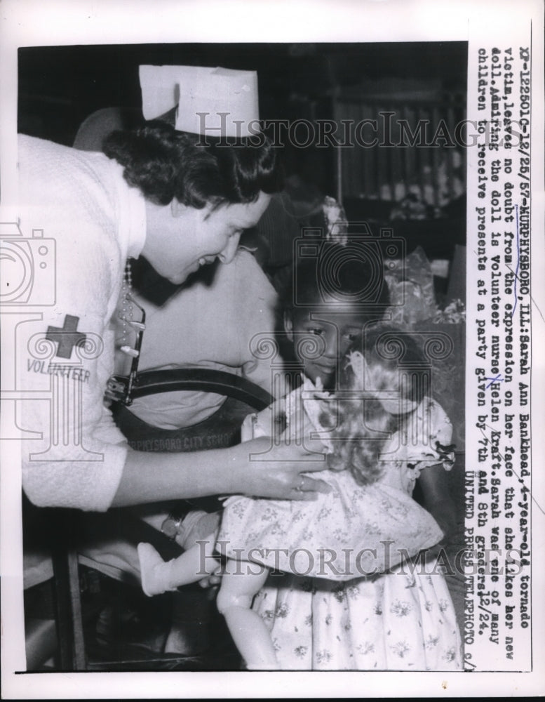 1958 Sarah Bankhead is a tornado victim that is loving her new doll - Historic Images