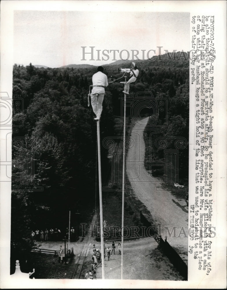 1969 Press Photo Joseph Bauer presents birthday cake to wife atop 90 foot pole - Historic Images