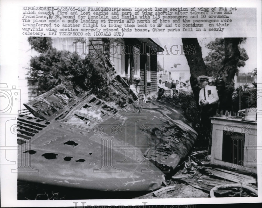 1965 Press Photo Firemen inspecting a large section of the wing of the Paa Jet - Historic Images