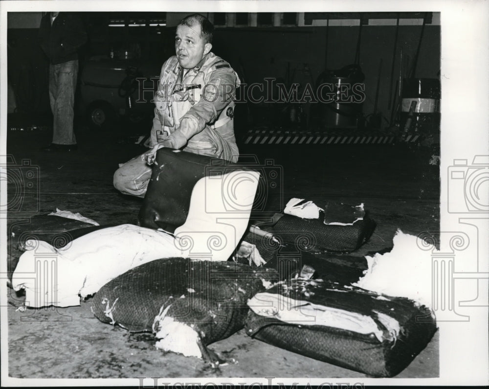 1965 Airman Robert Hannah on damage seats of Eastern Air Lines DC7B - Historic Images