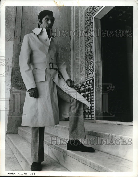 1969 Press Photo Man in new rubberized rain coat & herringbone pants - Historic Images