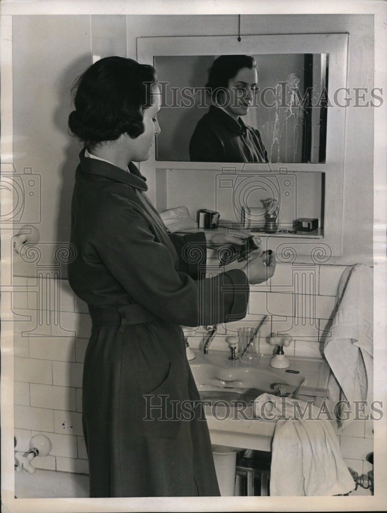 1945 Press Photo Woman in a bathroom with toothpaste uncapped from husband - Historic Images