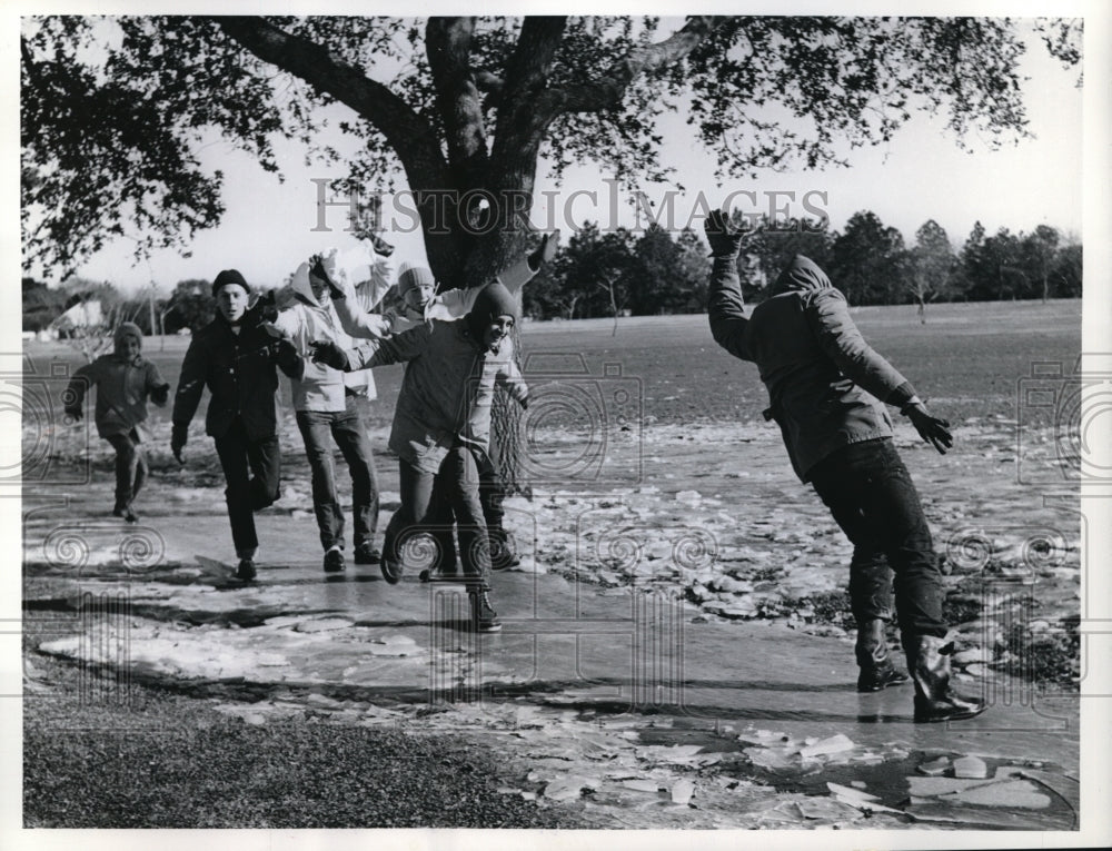 1962 New Orleand La boys sliding on unusual ice on sidewalks - Historic Images