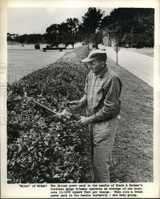 1962 Press Photo Black & Decker cordless hedge trimmers & battery pack in use - Historic Images