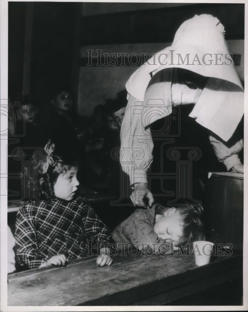 1946 Press Photo Child awakened for Red Cross milk in Ile De Sean, France - Historic Images