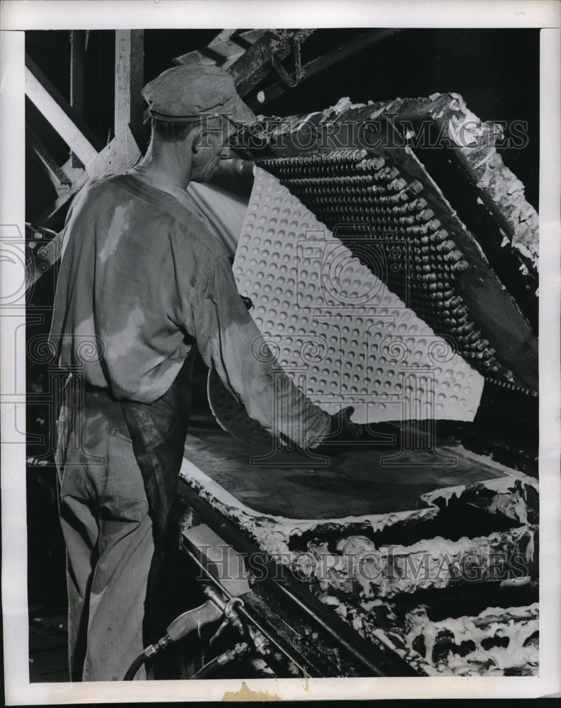 1947 Press Photo worker at a foam plant removing foam from mold - nec98498 - Historic Images