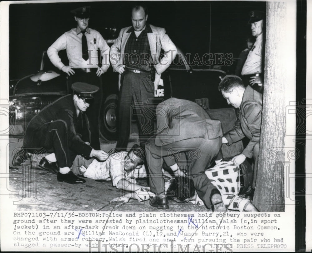 1956 Police hold down robbery suspects in a crack down on mugging. - Historic Images