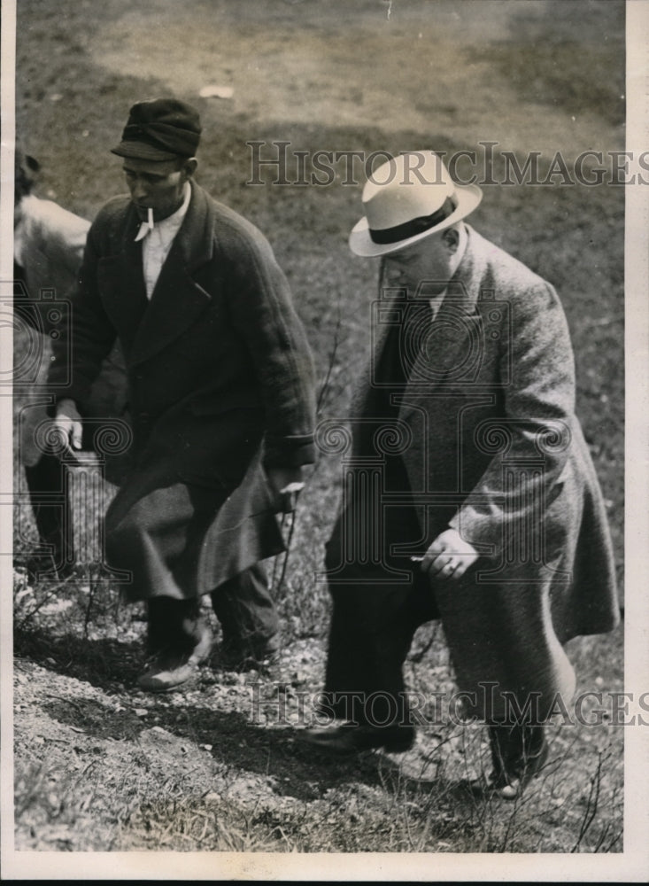 1934 George Zietlow and a detective looking for clues. - Historic Images