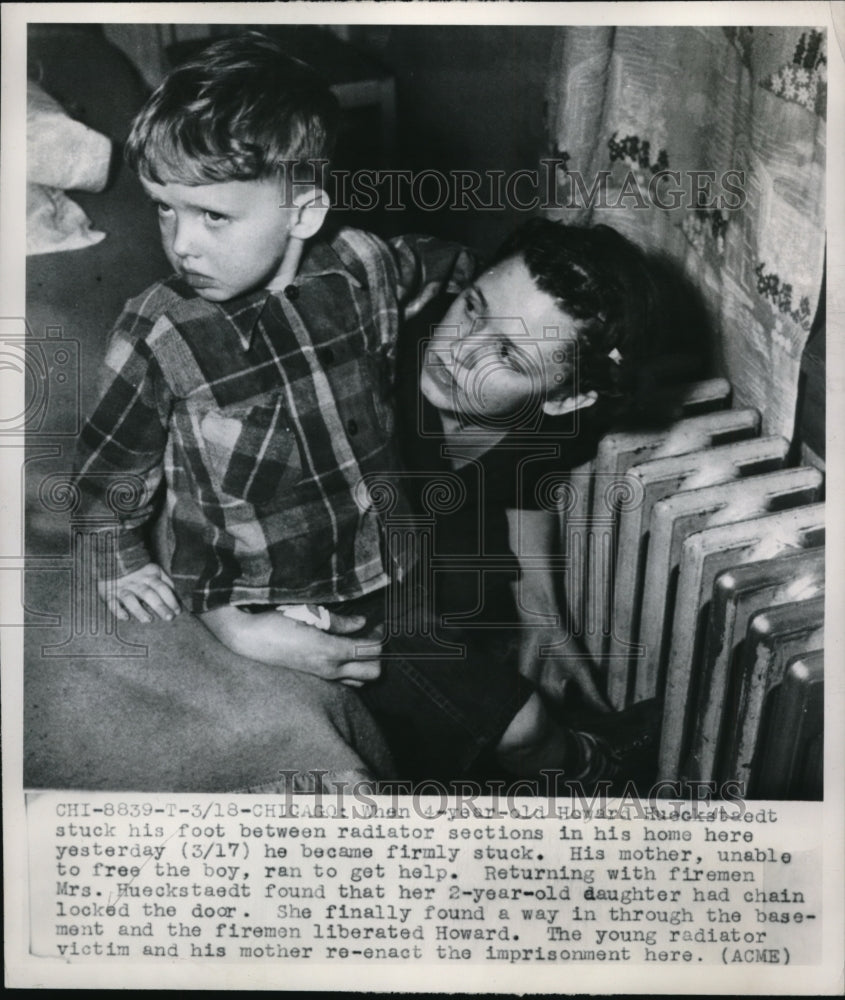 1950 4 yr old Howard Hueckstaedt gets foot stuck in radiator - Historic Images