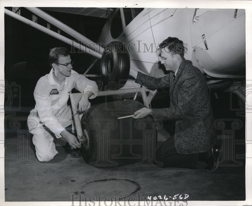 1956 Press Photo Comparing Goodyear Tires are Frederick Maiser and James Denning - Historic Images