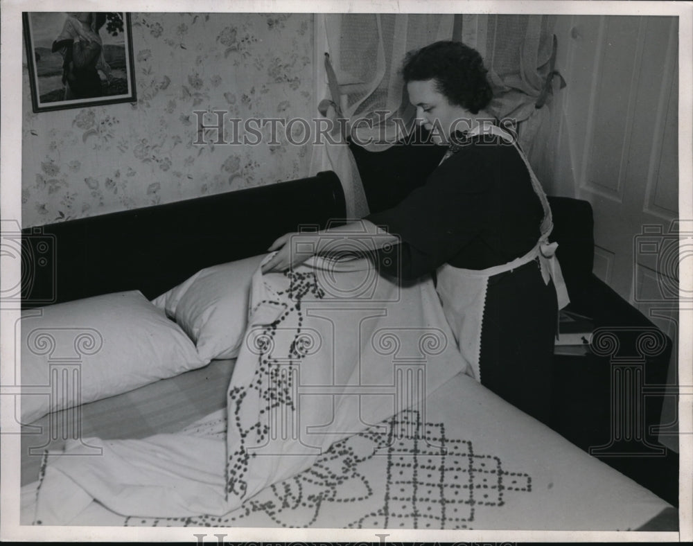 1938 Mrs. Irene Kite pulls a hand worked coverlet  - Historic Images