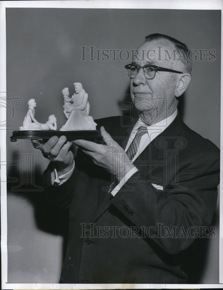 1957 John Reiner Sr wealthy oil &amp; coal dealer holds religious statue - Historic Images