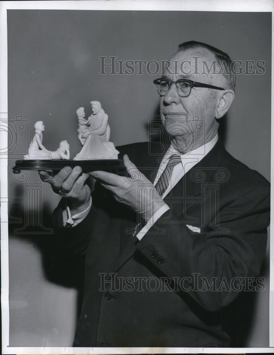 1957 John Reiner Sr wealthy oil & coal dealer holds religious statue - Historic Images