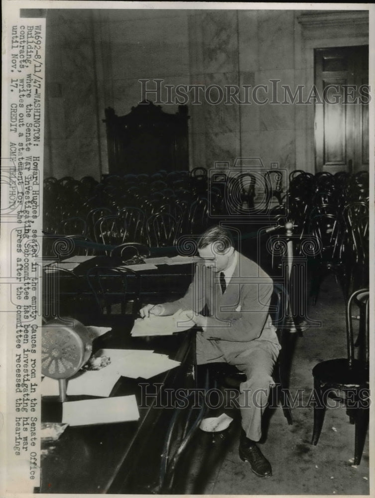 1947 Washington DCHoward Hughes seated in empty caucus room in-Historic Images