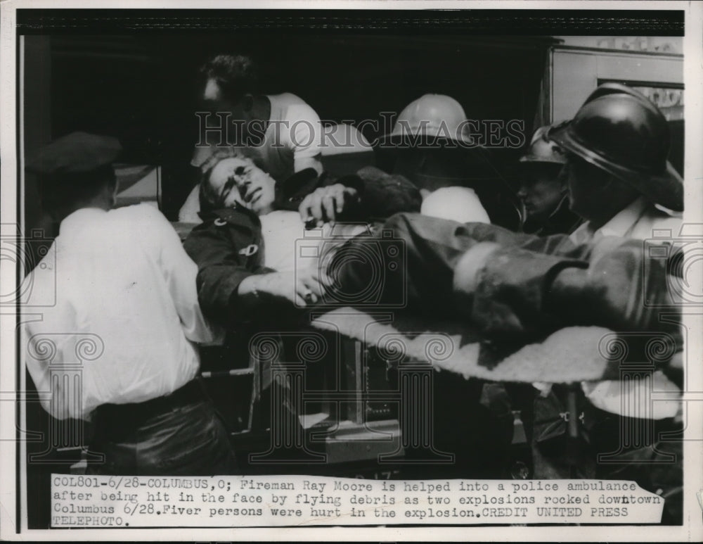 1952 Press Photo Fireman Ray Moore being helped into a police ambulance - Historic Images