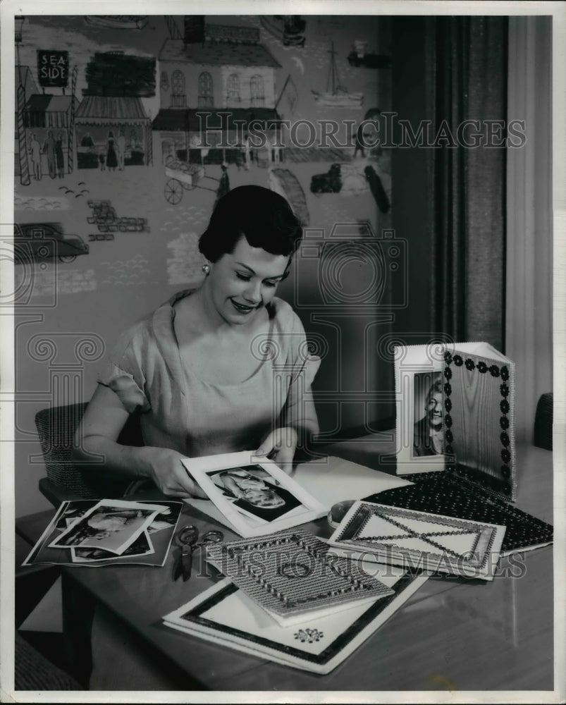 1955 A festive flourish is added to the portrait Christmas gift by-Historic Images
