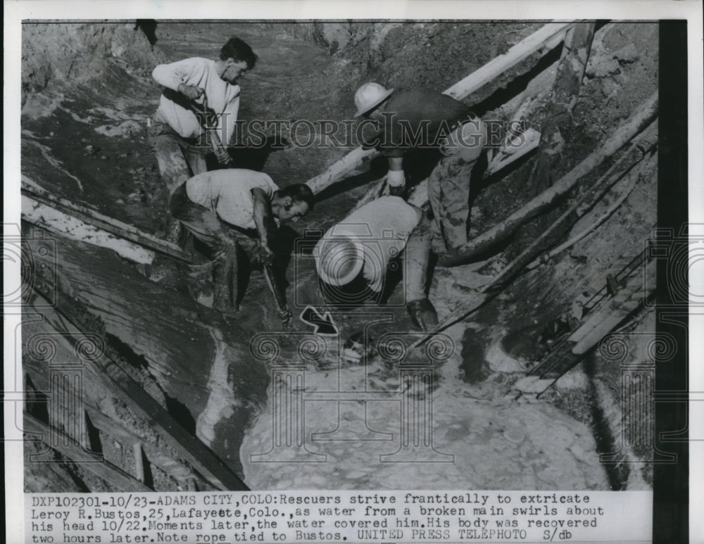 1956 Press Photo The rescuers strive hard to extricate Leroy Bustos - Historic Images