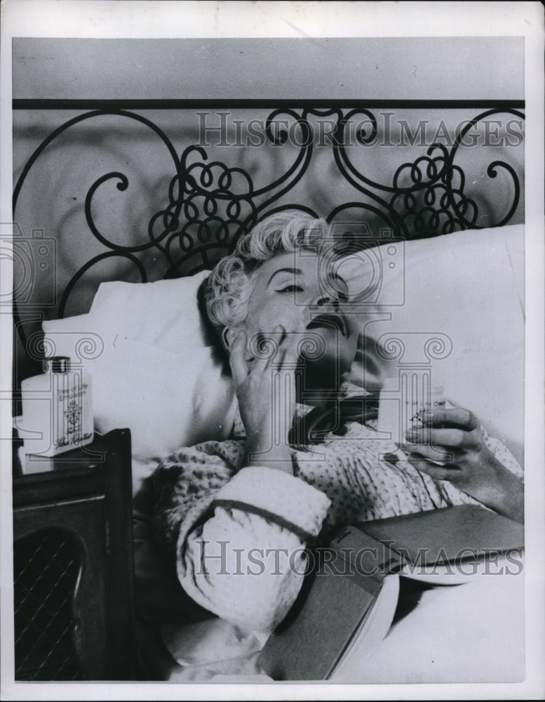 1958 Press Photo Woman caring for her face by applying facial cream - Historic Images