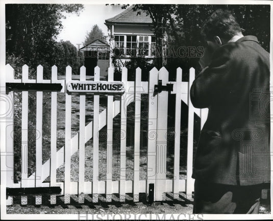1961 Press Photo Dave Bethman taking picture of gate of "White House" - Historic Images