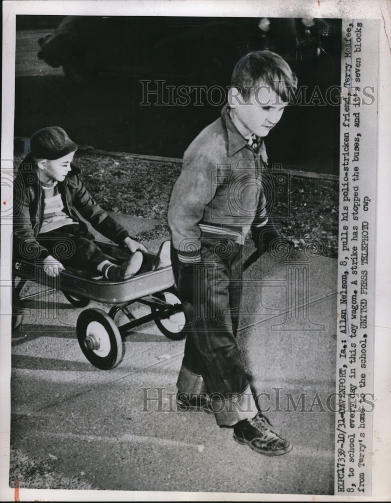 1952 Press Photo Allan Nelson, 8, pulls his polio-stricken friend Terry McAfee - Historic Images