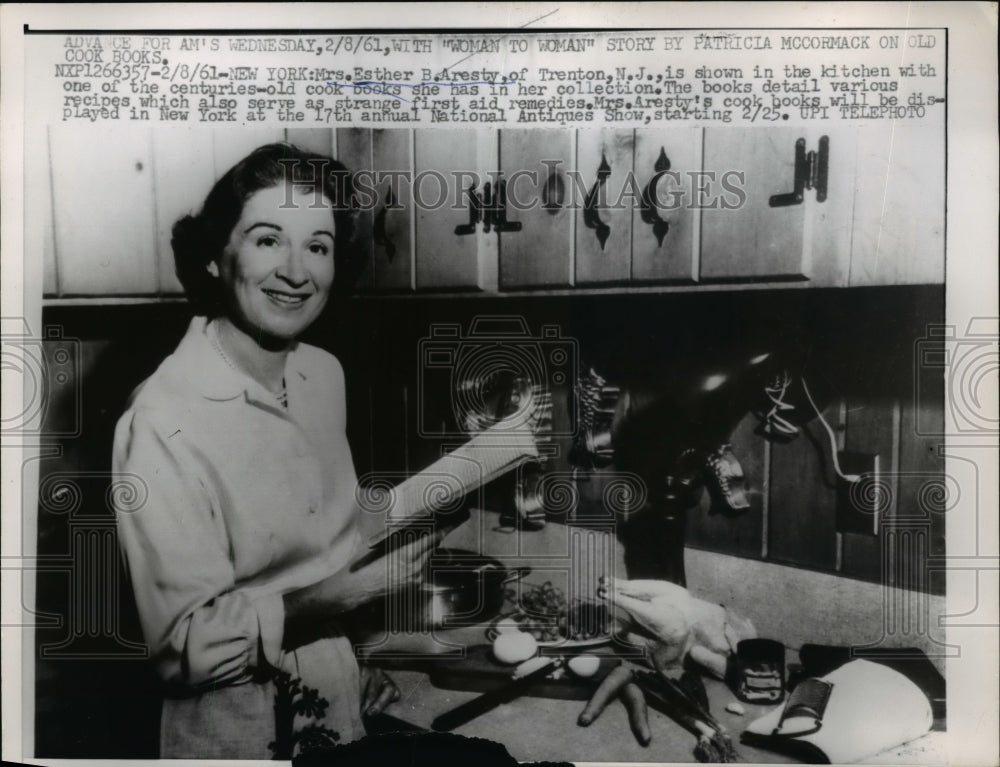 1961 Press Photo NYC Mrs Esther B Aresty in kitchen with century old cookbook - Historic Images