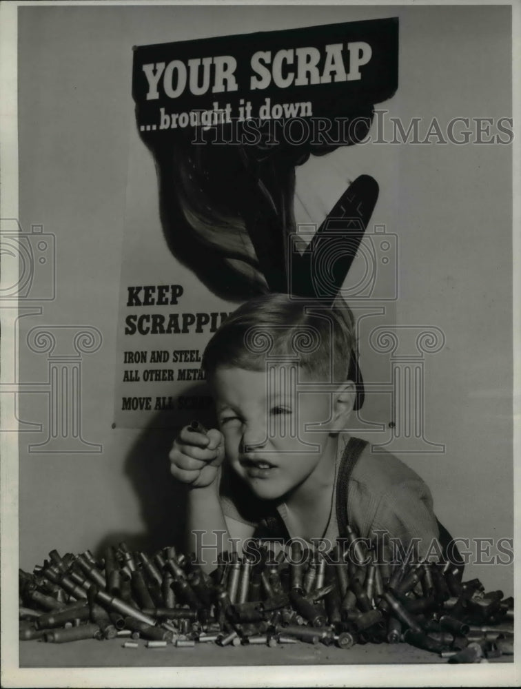 1943 Willard Hatch Jr. and his collection of empty bullet shells-Historic Images