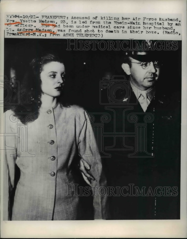 1949 Press Photo Mrs. Yvette Madsen is being escorted by an officer. - Historic Images