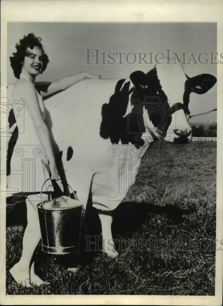 1941 Betty McDonald admires Carnation Homestead Madcap-Historic Images