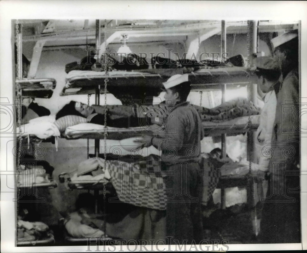 1970 Press Photo Crewman aboard Perivian Warship attend to Earthquake victims. - Historic Images