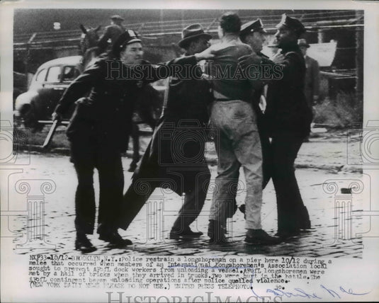 1953 Press Photo Brooklyn Police restrain a longshoreman on a pier during a mele - Historic Images