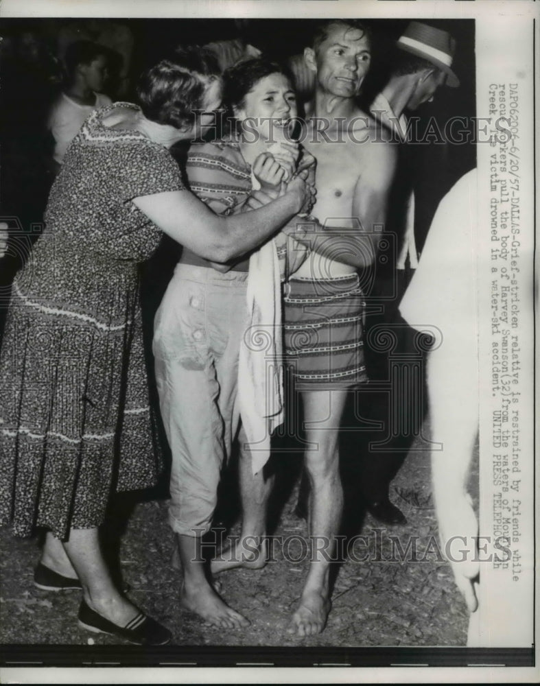 1957 Press Photo Family of the victim restrained by friends - Historic Images