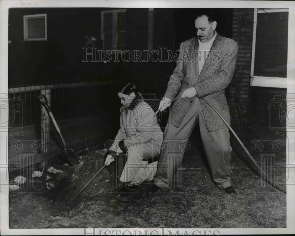 1956 Press Photo Jack Stone &amp; Son Barry Trying to Pull Out Buried Garden Hose - Historic Images