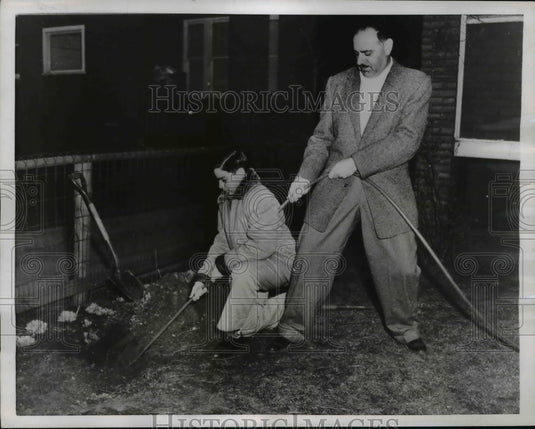 1956 Press Photo Jack Stone & Son Barry Trying to Pull Out Buried Garden Hose - Historic Images