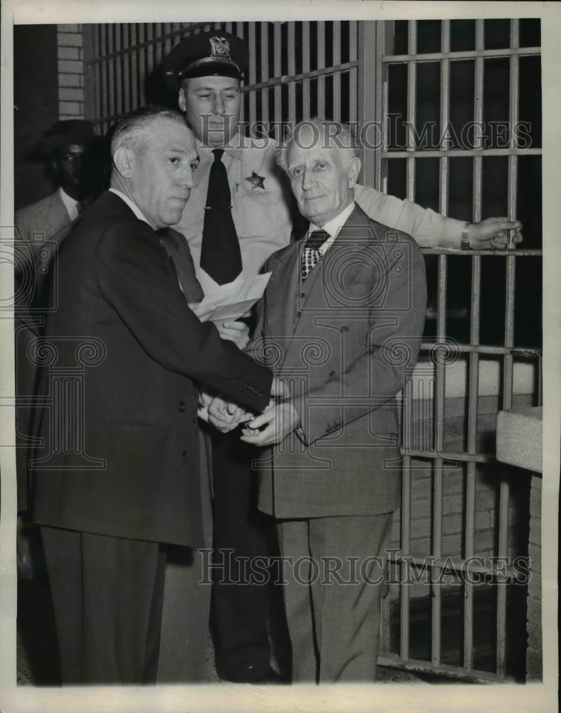 1949 Press Photo U.S.Deputy Marshal Ben Golabrer puts handcuff to Sigmund Engel - Historic Images