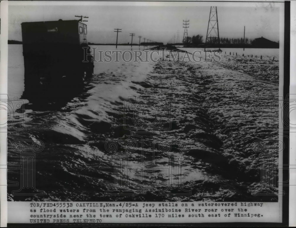 1956 Press Photo Oakville Manitoba Canada  a jeep stalled in floodwaters - Historic Images